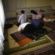 Uighur refugee men pray where they are housed in a gated complex in the central city of Kayseri, Turkey.